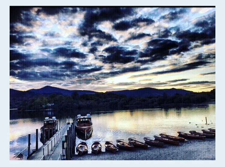 Dramatic skies over Derwentwater with reflections in the water 